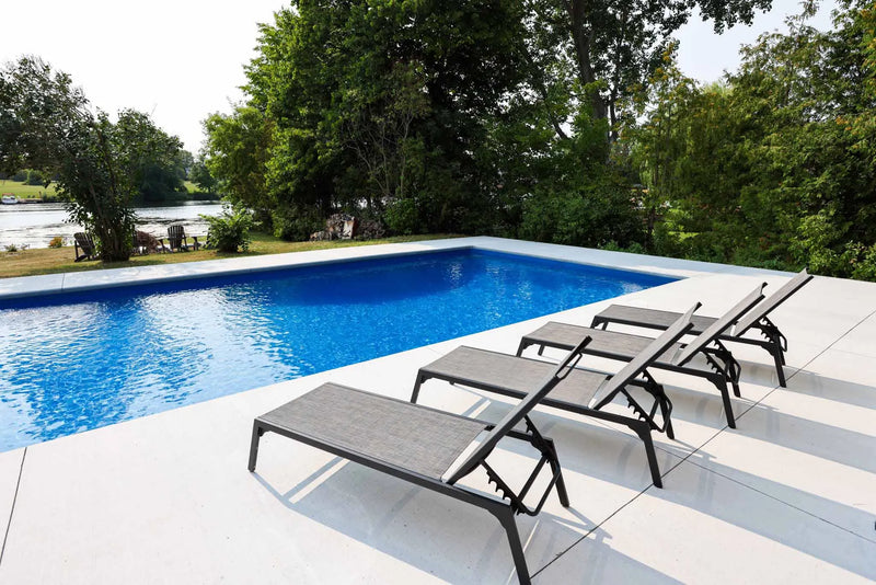 Modern rectangular pool with white stone deck | HB Pools