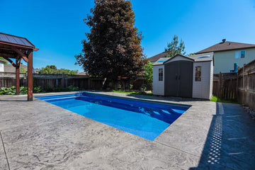 In-Ground Rectangular Pool construction in Rockland surrounded by Stamped Concrete and a wood pool pavillion