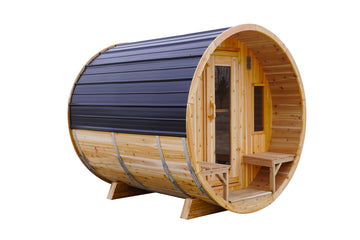 A wooden barrel-style sauna with a natural wood exterior, dark gray metal roof panels, and a small wooden bench inside, shown on a plain white background.
