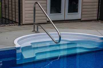 Close-up of vinyl inground pool steps with stainless steel handrail installed by HB Pools in Limoges Ontario, featuring clean, modern design and durable pool liner.