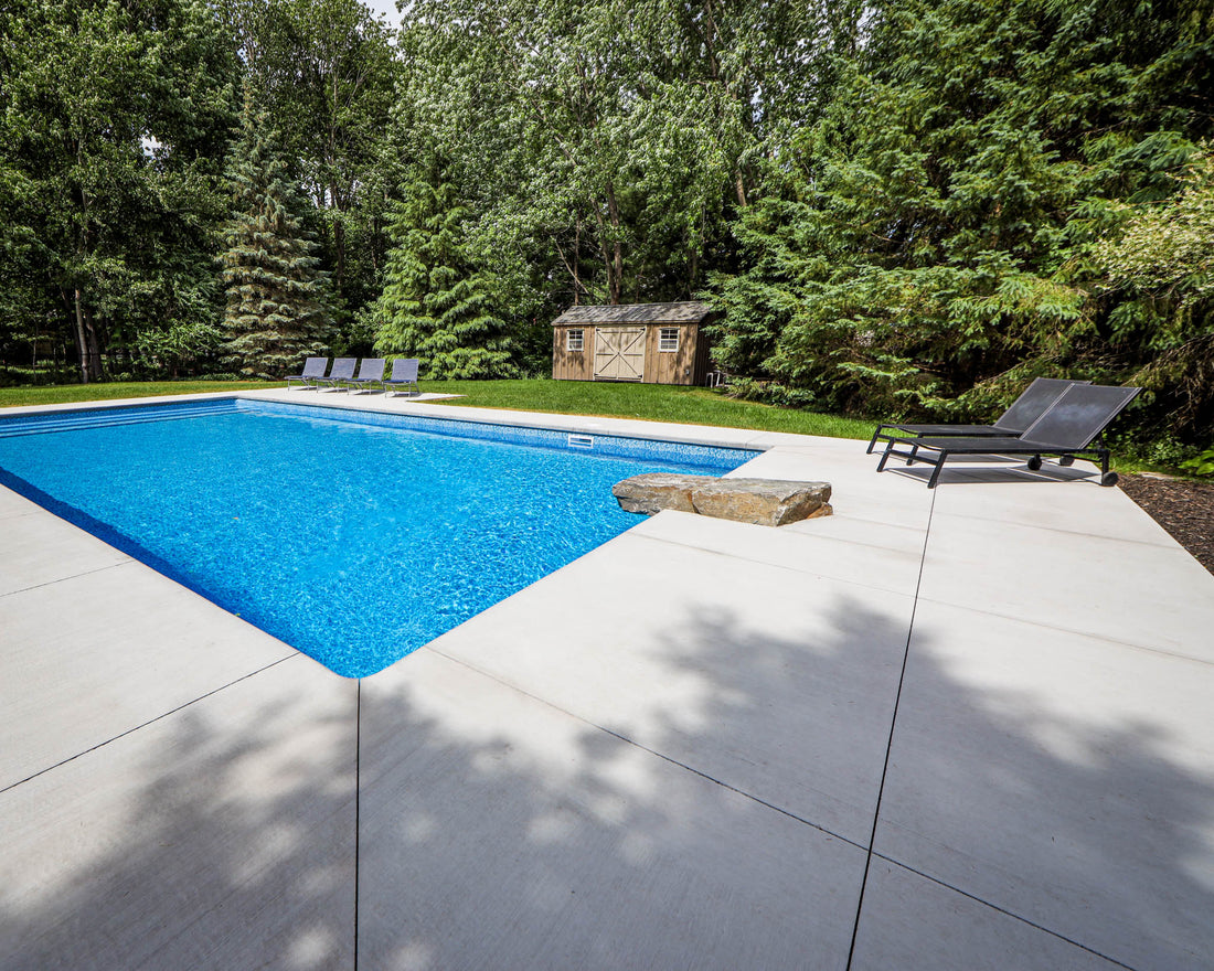 Inground Pool in Ottawa Manotick with a diving rock & lounger chairs