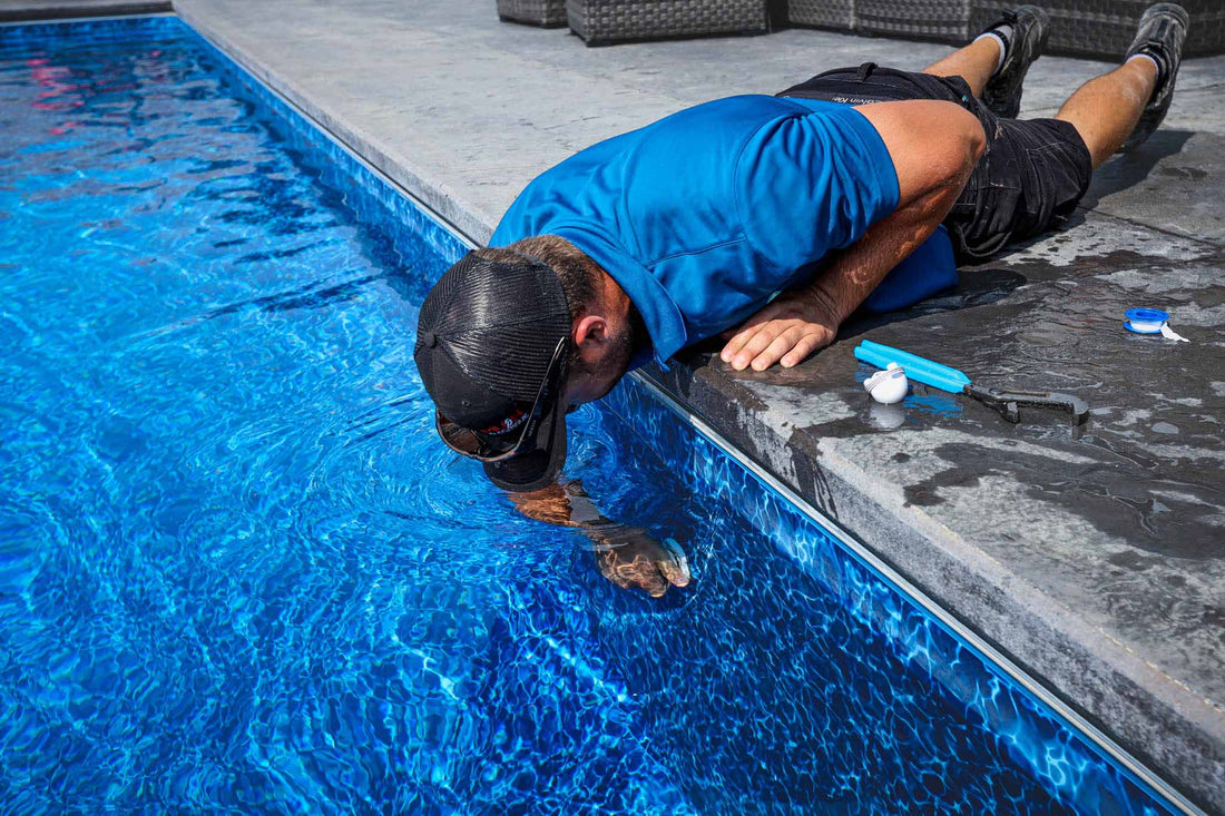 HB Pools service technician installing a plug to close a swimming pool for the winter.