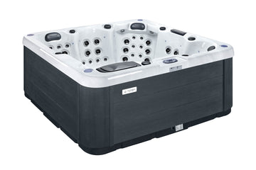 A rectangular hot tub with a dark charcoal gray exterior and a white interior, featuring multiple built-in jets and seating areas, shown on a plain white background.