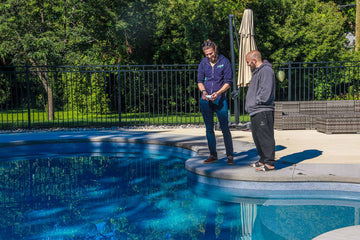 HB Pools Installation specialist talks with Ottawa homeowner around a new freeform pool construction project