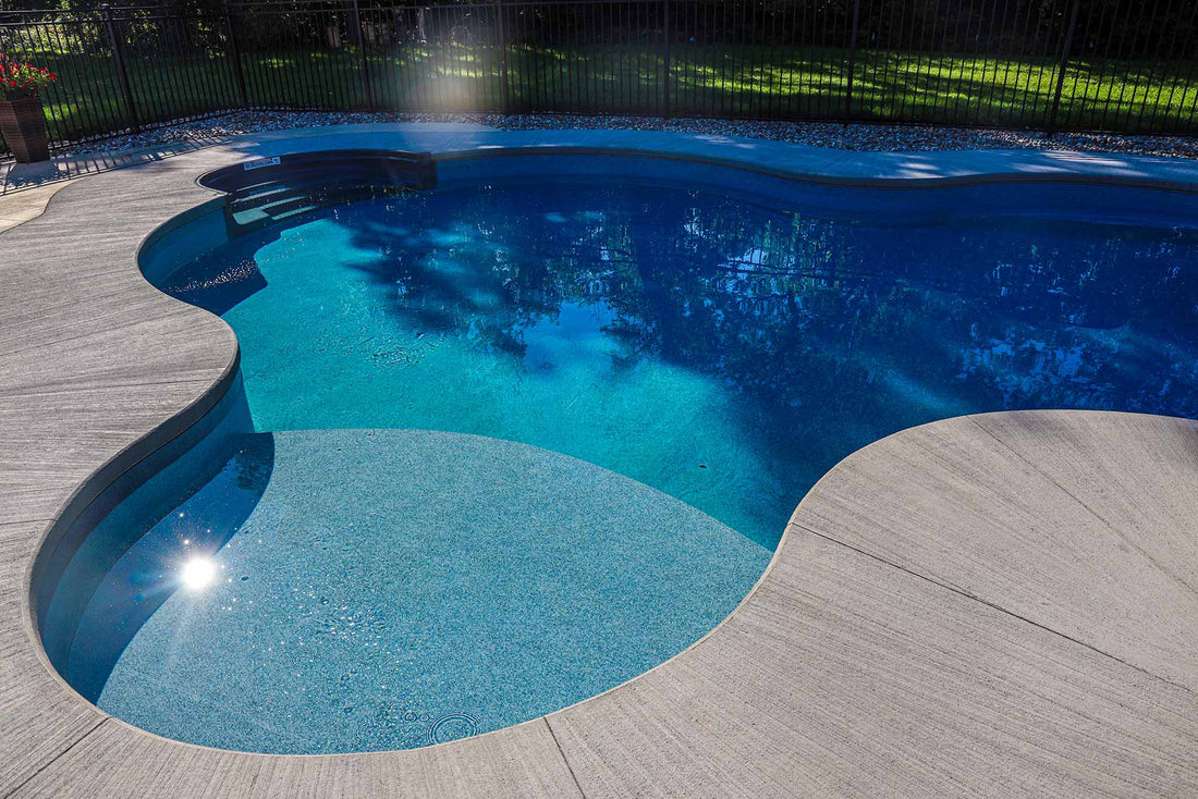New curved pool installation in Ottawa with freeform tanning ledge