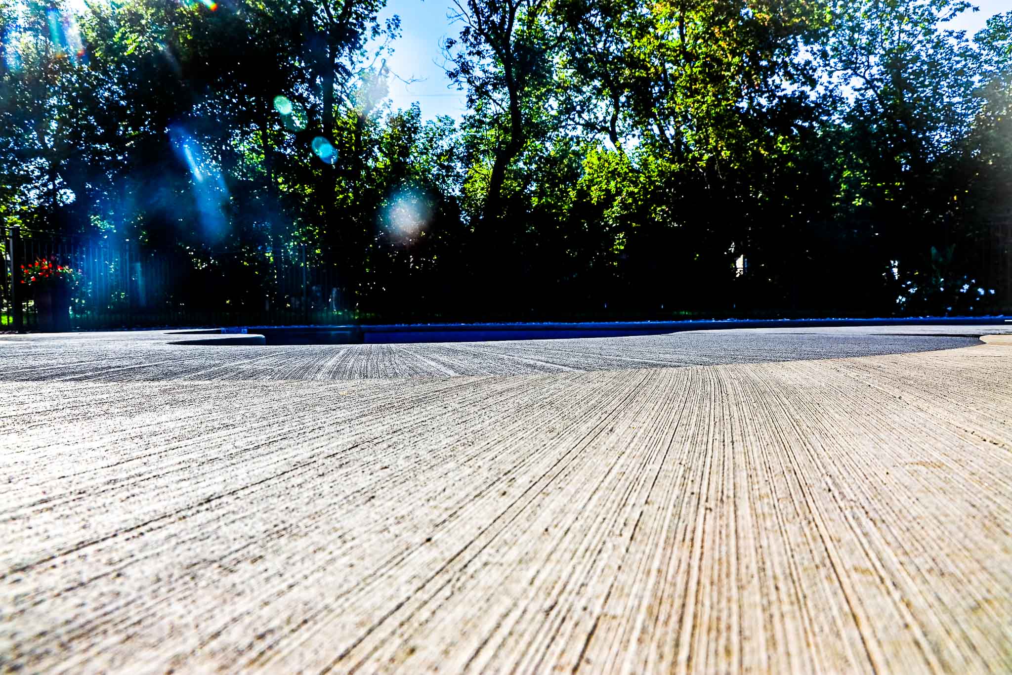 New pool construction project showcasing two-tone brushed concrete closeup 