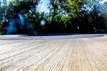 New pool construction project showcasing two-tone brushed concrete closeup 
