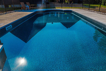 New pool construction in Clarence-Rockland showcasing deep end bottom profile and stamped concrete