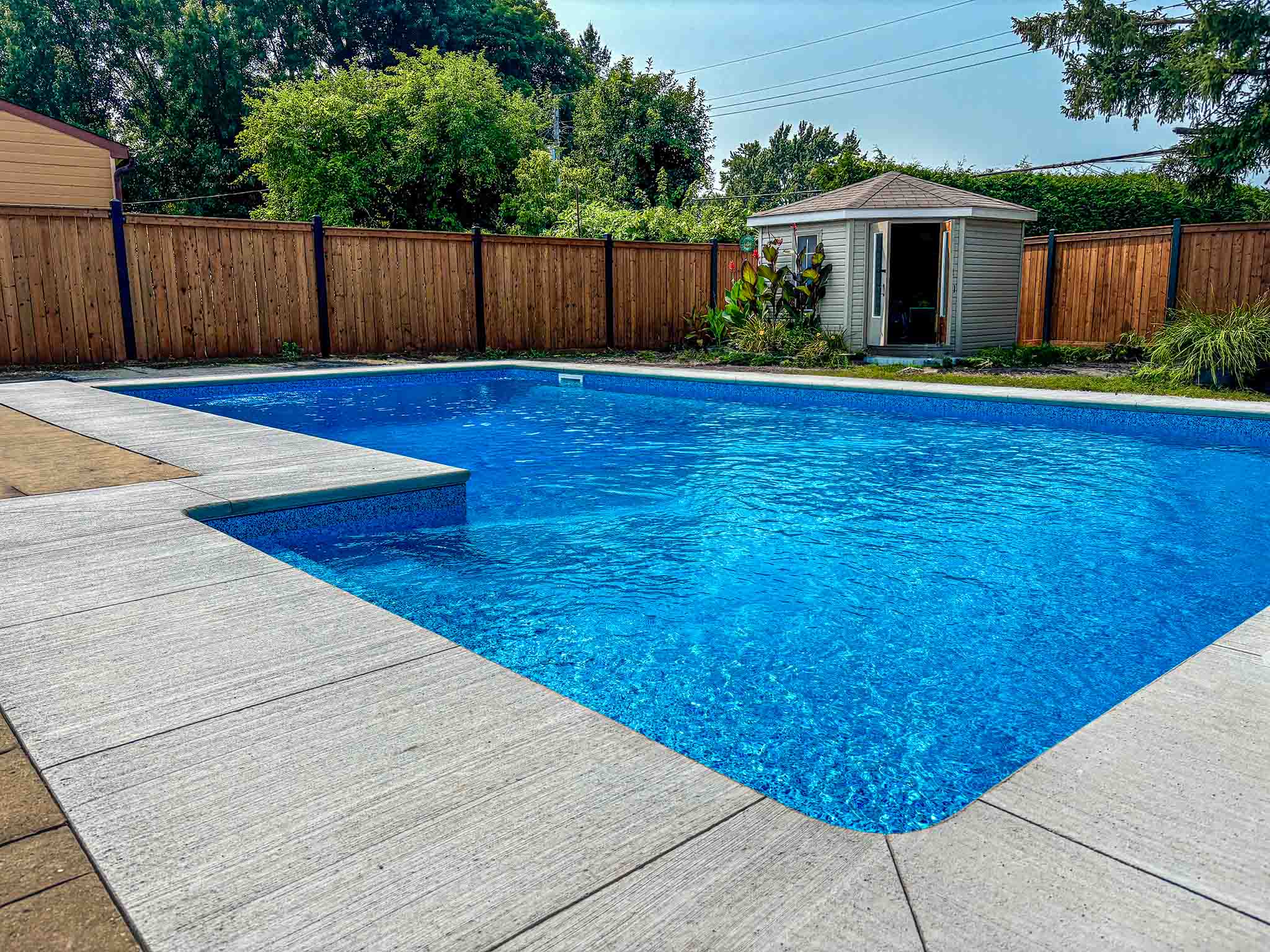 Overview of in ground pool finished with broom finish concrete