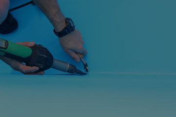 Hands of a Pool Technician using tools to weald a liner in place, representing liner replacement