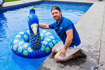 Pool Technician With Inflatable Swan At Pool Closing in Cumberland