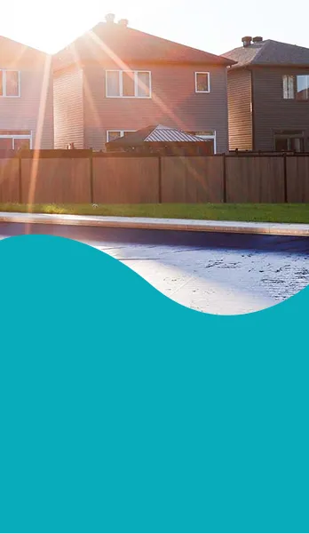 A sunny backyard with a pool being prepared for the season using pool opening services | HB Pools