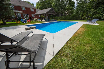 Inground backyard swimming pool ready for summer after professional pool opening services | HB Pools