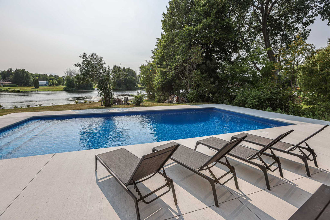 rectangular inground pool with concrete deck overlooking Rideau River in Manotick Ontario