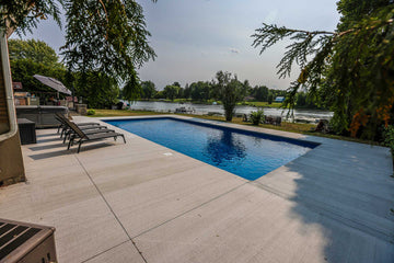 rectangular inground pool with concrete patio overlooking Rideau River in Manotick Ontario