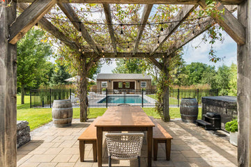 backyard pergola with dining table overlooking inground pool in St-Isidore Ontario
