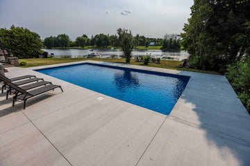 rectangular inground pool with concrete patio overlooking Rideau River in Manotick Ontario